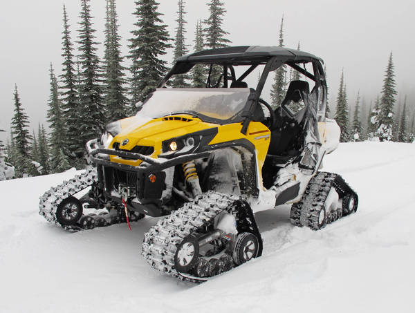 A snow patrol ATV parked in a harsh, remote mountaintop setting.